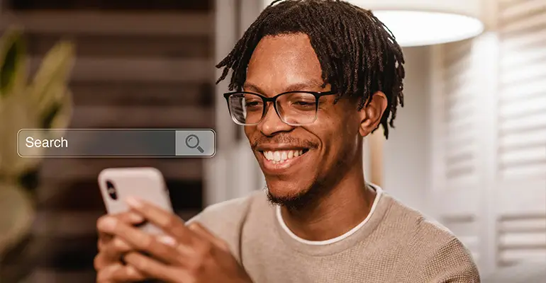 A customer doing a Google search on their phone smiling