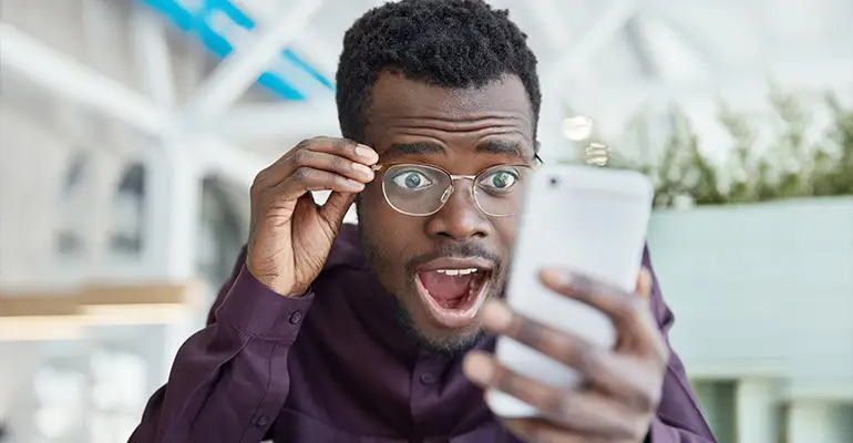 A client happy about what they see on the phone screen